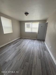 835 West 30th Street, Unit 1 Jacksonville, FL 32209 - Photo 3 of 8 an empty room with wooden floor and windows