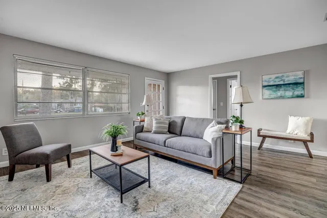 a dining room with furniture and wooden floor