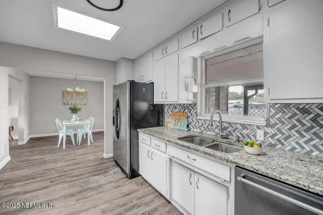 a bedroom with a large bed and a chandelier fan