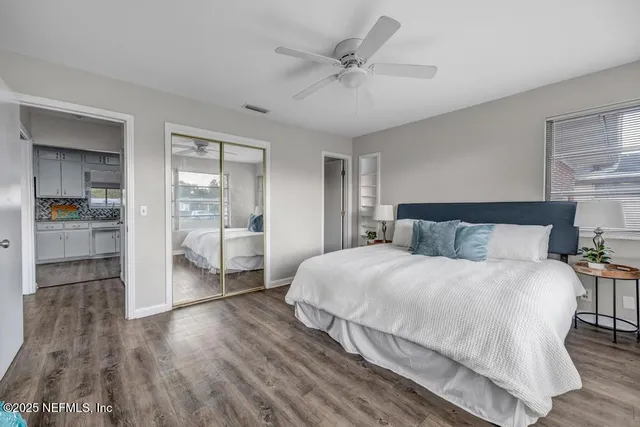 a spacious bedroom with a bed and a chandelier