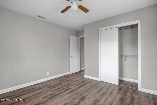 a view of room with window and ceiling fan