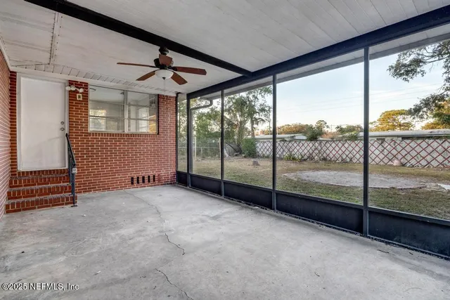wooden floor in an empty room with a large window
