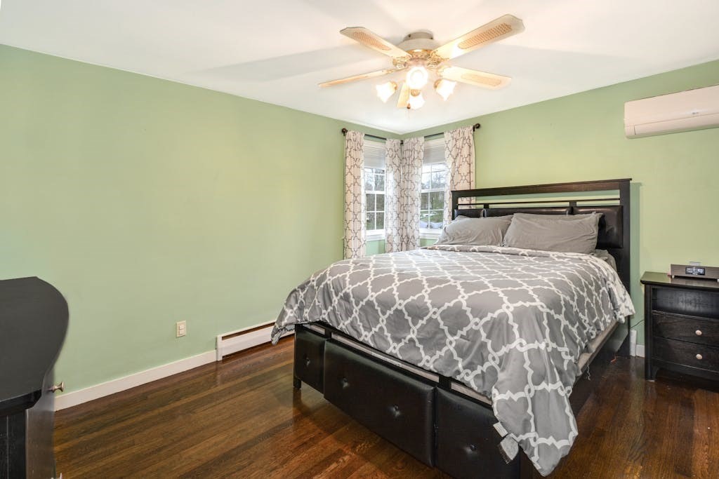 20 Oakview Circle Medway, MA 02053 - Photo 14 of 33 a bed sitting in a bedroom next to a window and a chandelier