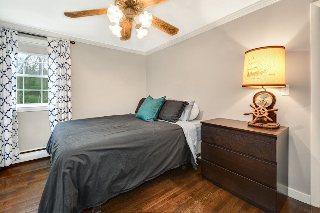 20 Oakview Circle Medway, MA 02053 - Photo 17 of 33 a bedroom with a bed and a chandelier