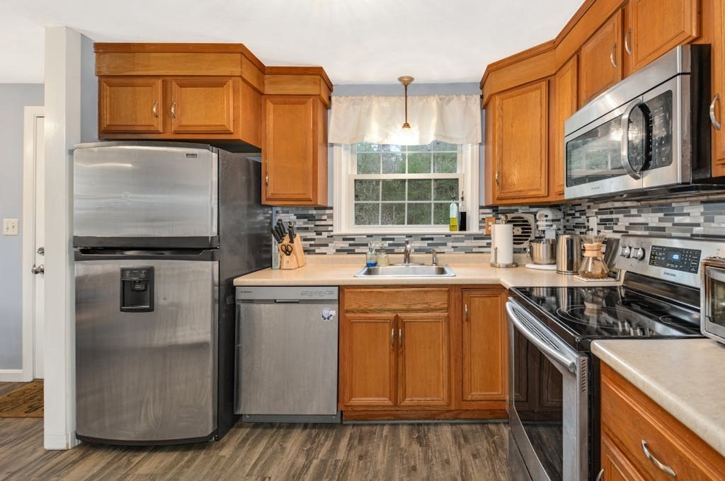 20 Oakview Circle Medway, MA 02053 - Photo 10 of 33 a kitchen with stainless steel appliances granite countertop a stove a sink and a microwave