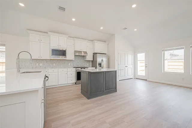 a large kitchen with cabinets