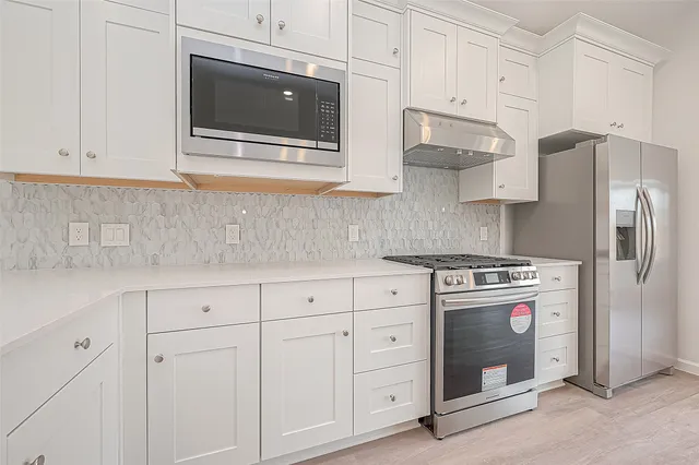 a kitchen with a sink stainless steel appliances and cabinets