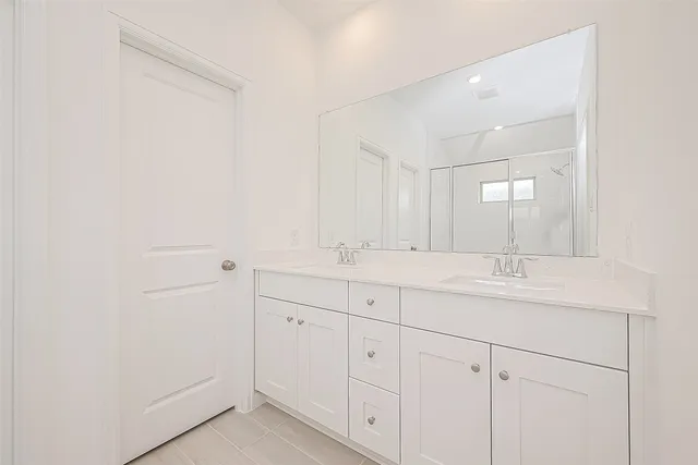 a bathroom with a double vanity sink and mirror
