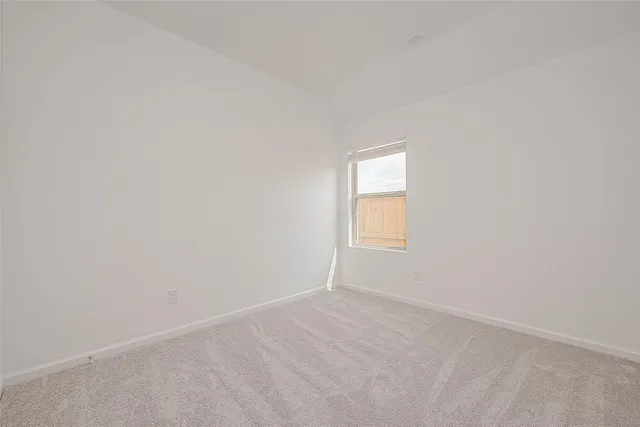 a view of an empty room and a window