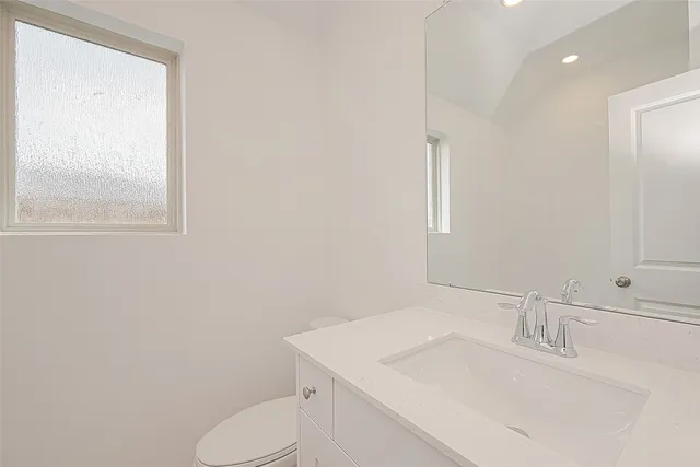 a bathroom with a sink toilet and mirror