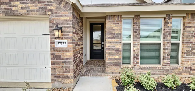 a view of a brick house with windows