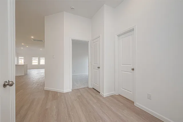 a view of a hallway with wooden floor