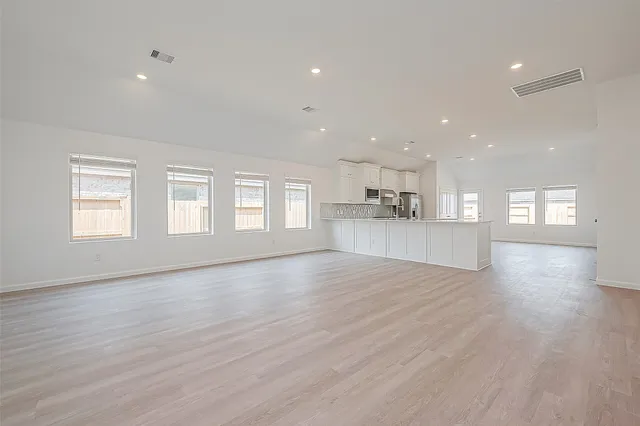 a view of hallway with wooden floor