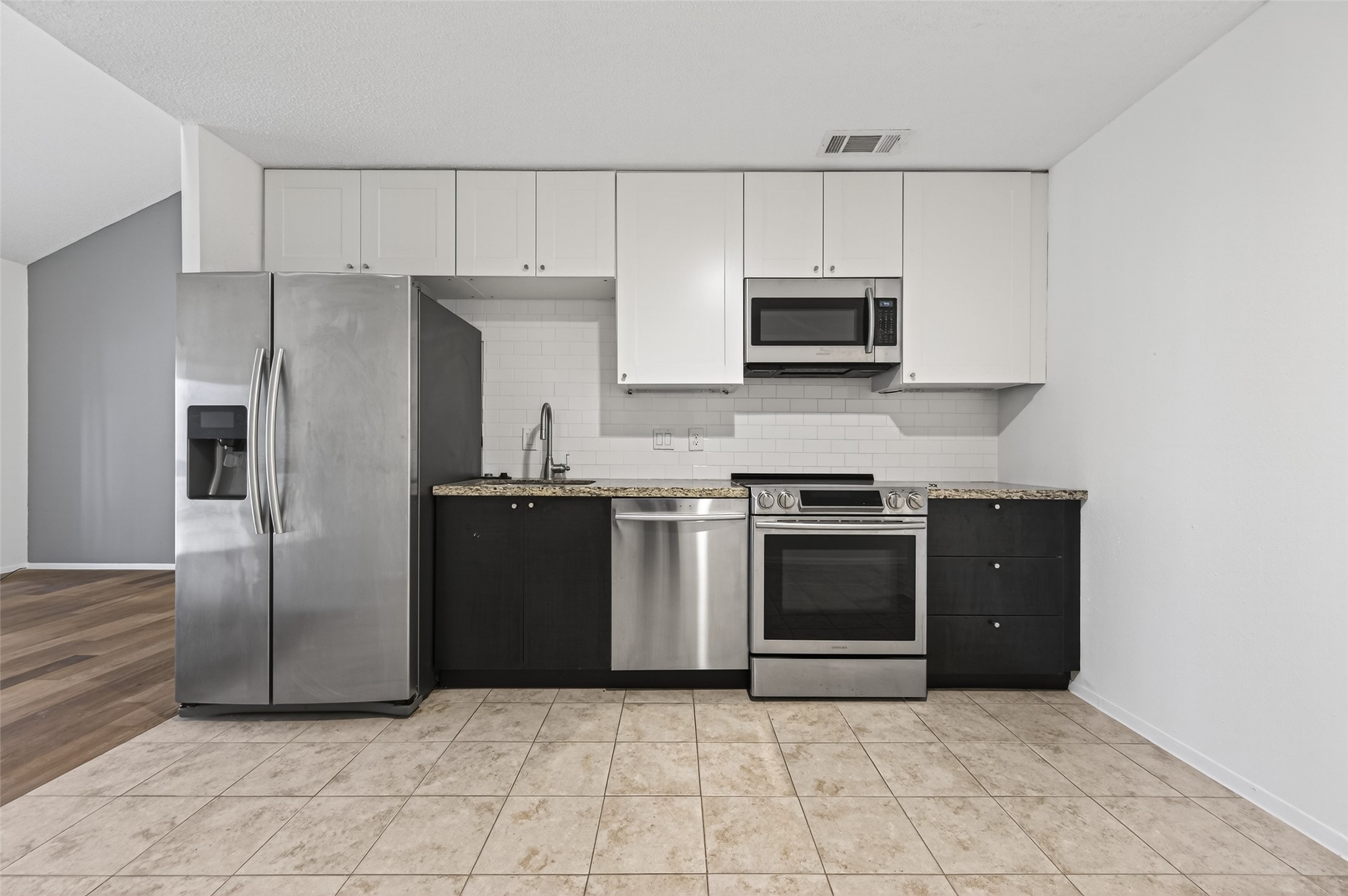 12900 Walden Road, Unit 108A Montgomery, TX 77356 - Photo 11 of 42 a kitchen with stainless steel appliances granite countertop a refrigerator and a stove
