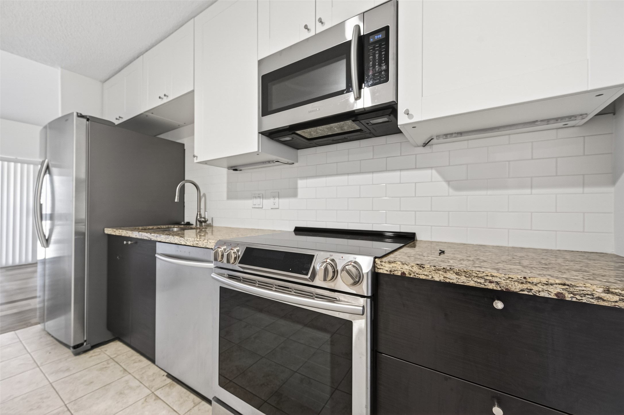 12900 Walden Road, Unit 108A Montgomery, TX 77356 - Photo 12 of 42 a kitchen with a stove and a microwave