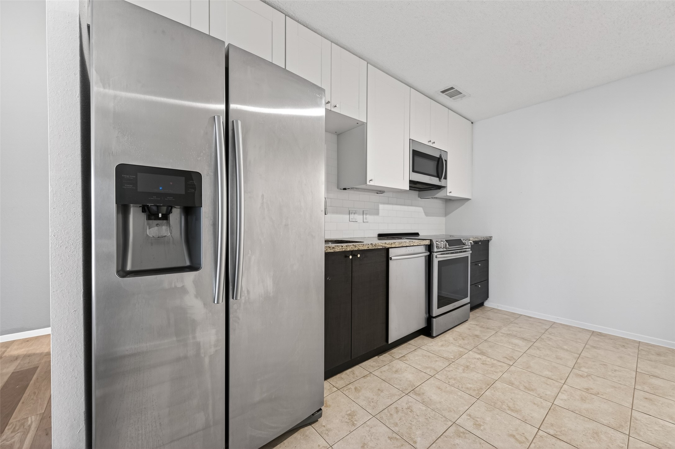 12900 Walden Road, Unit 108A Montgomery, TX 77356 - Photo 14 of 42 a kitchen with stainless steel appliances a refrigerator and a sink