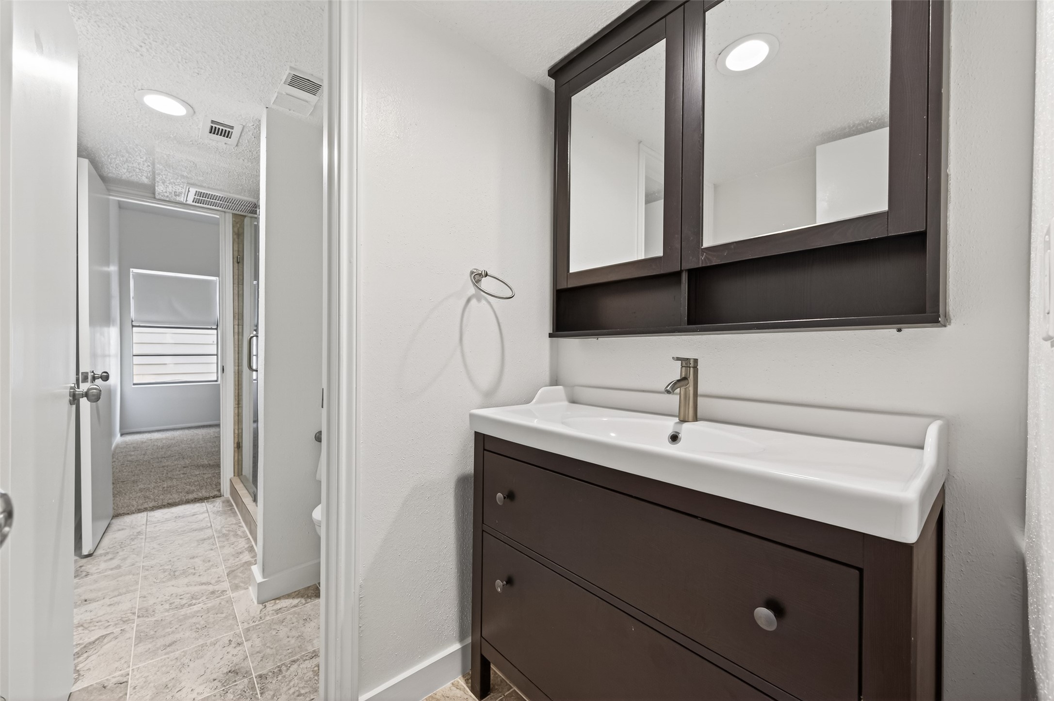 12900 Walden Road, Unit 108A Montgomery, TX 77356 - Photo 21 of 42 a bathroom with a sink and a mirror