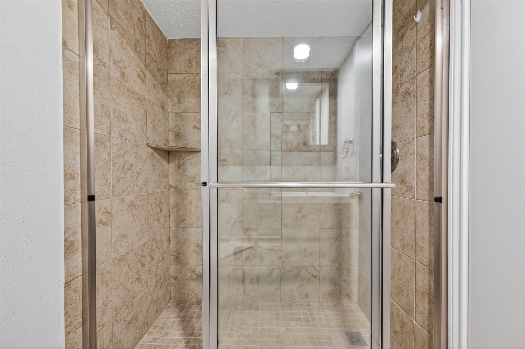 12900 Walden Road, Unit 108A Montgomery, TX 77356 - Photo 35 of 42 a bathroom with a glass shower door