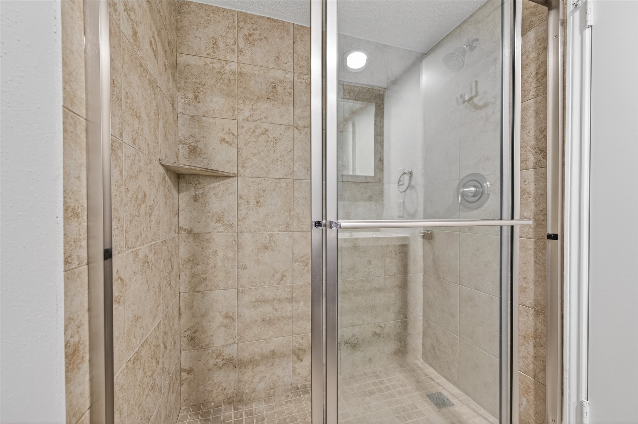 12900 Walden Road, Unit 108A Montgomery, TX 77356 - Photo 36 of 42 a bathroom with a glass shower door