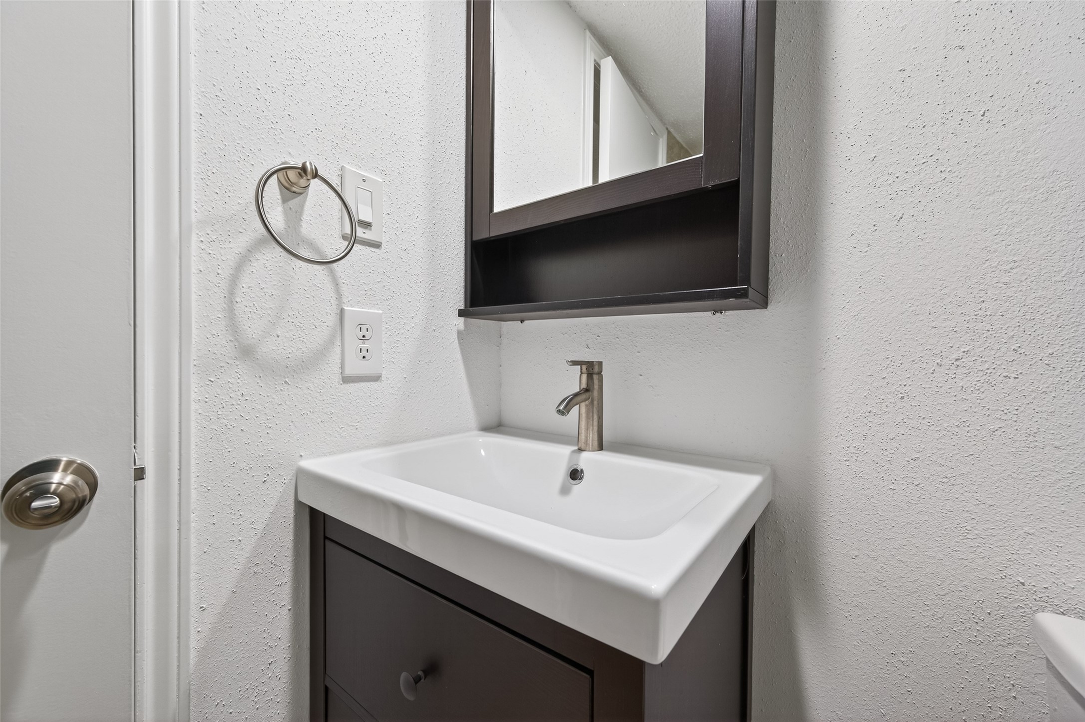 12900 Walden Road, Unit 108A Montgomery, TX 77356 - Photo 37 of 42 a bathroom with a sink a mirror and a toilet