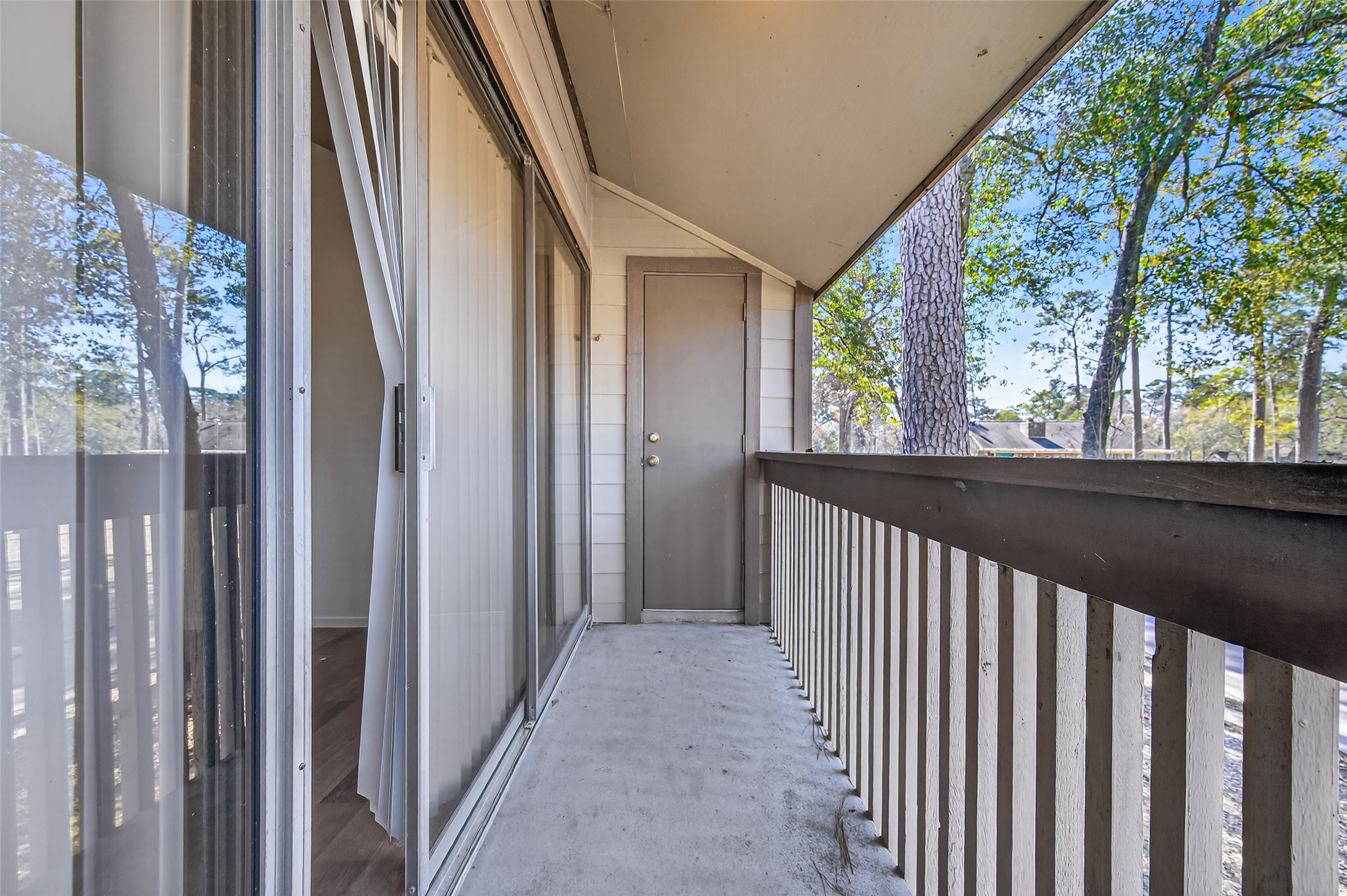 12900 Walden Road, Unit 108A Montgomery, TX 77356 - Photo 38 of 42 a view of a porch with wooden floor and outdoor space