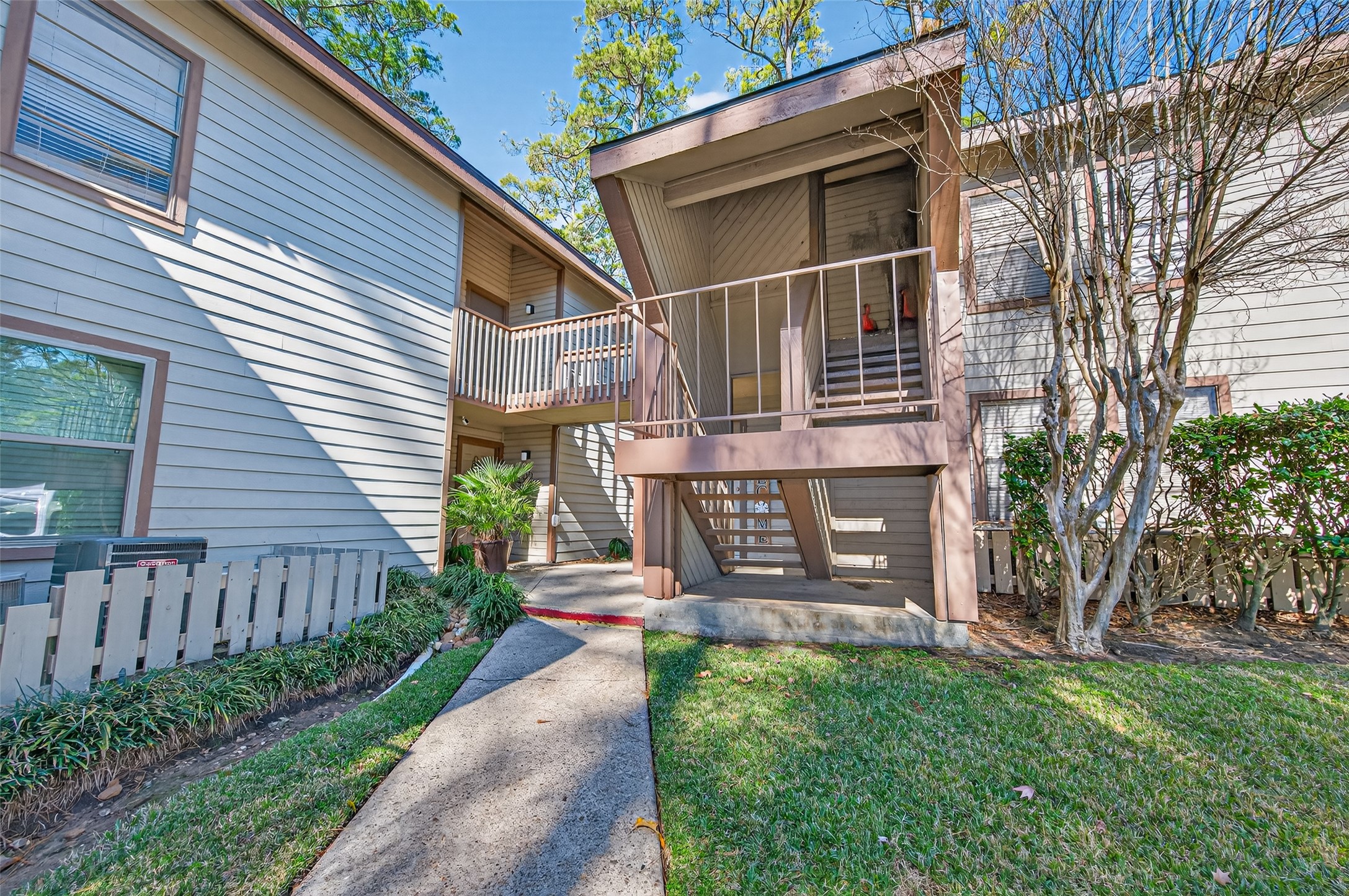 12900 Walden Road, Unit 108A Montgomery, TX 77356 - Photo 6 of 42 a view of a house with brick walls and a fence