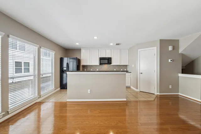 a view of a kitchen with wooden floor