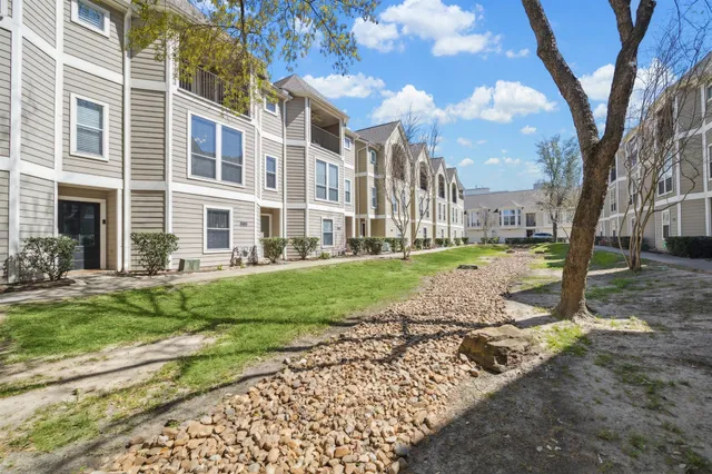 a view of a park with a large tree