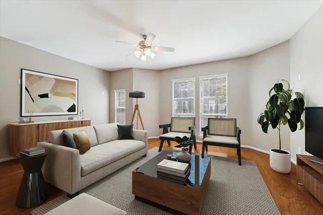a living room with furniture and a potted plant