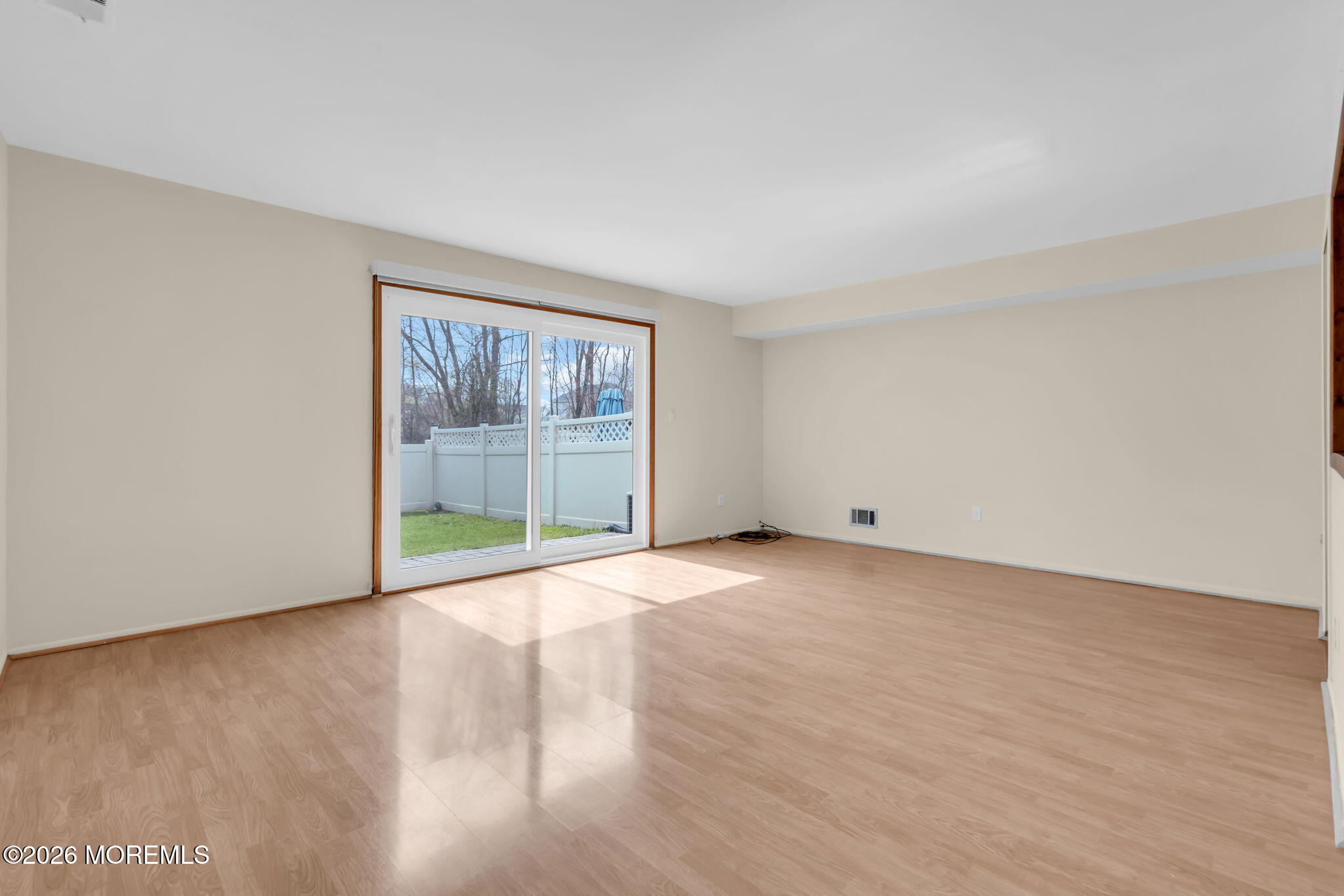 633 Randall Way Aberdeen, NJ 07747 - Photo 12 of 28 a view of an empty room with wooden floor and a window