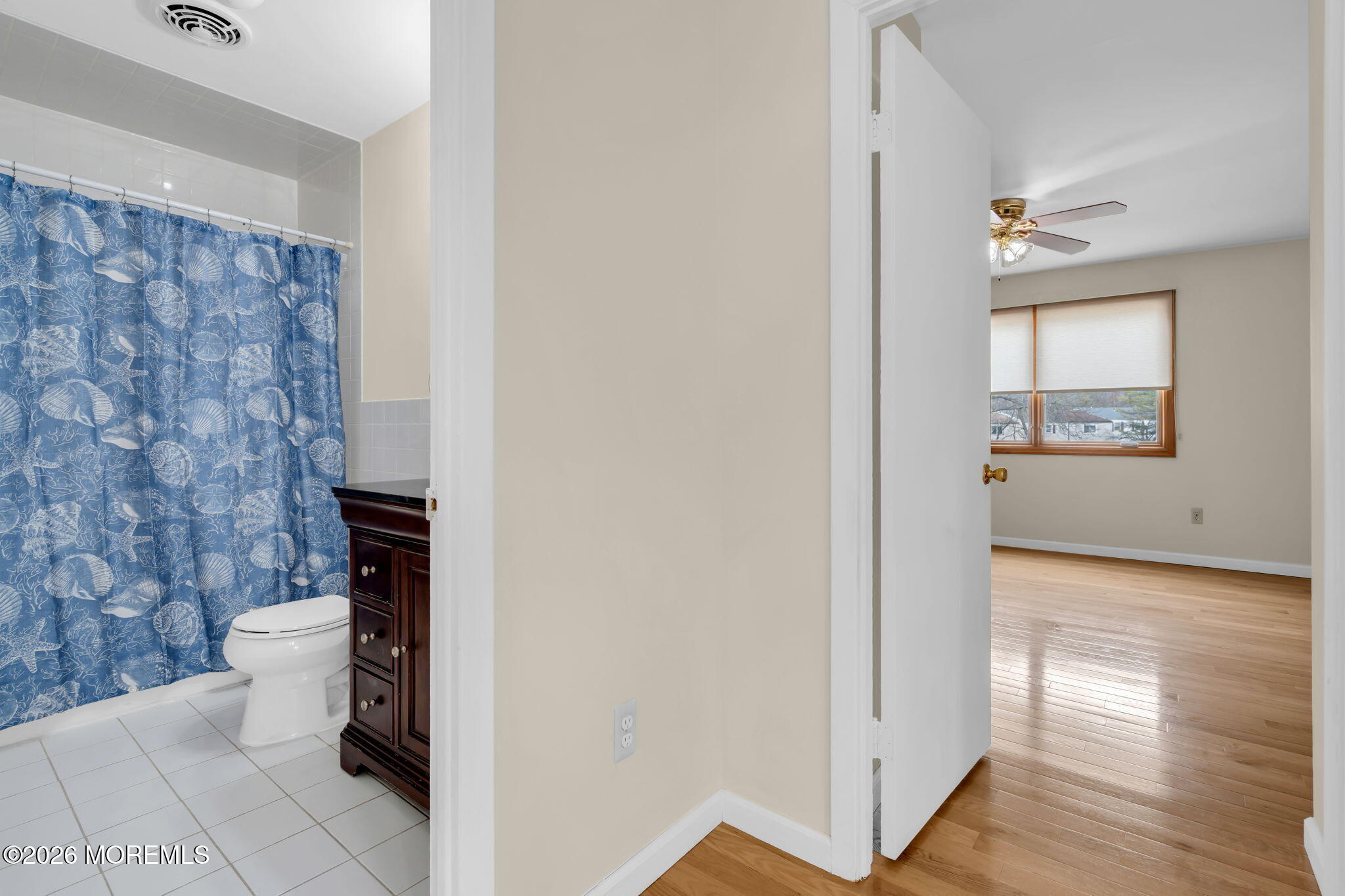 633 Randall Way Aberdeen, NJ 07747 - Photo 18 of 28 a view of a hallway with wooden floor and a bathroom