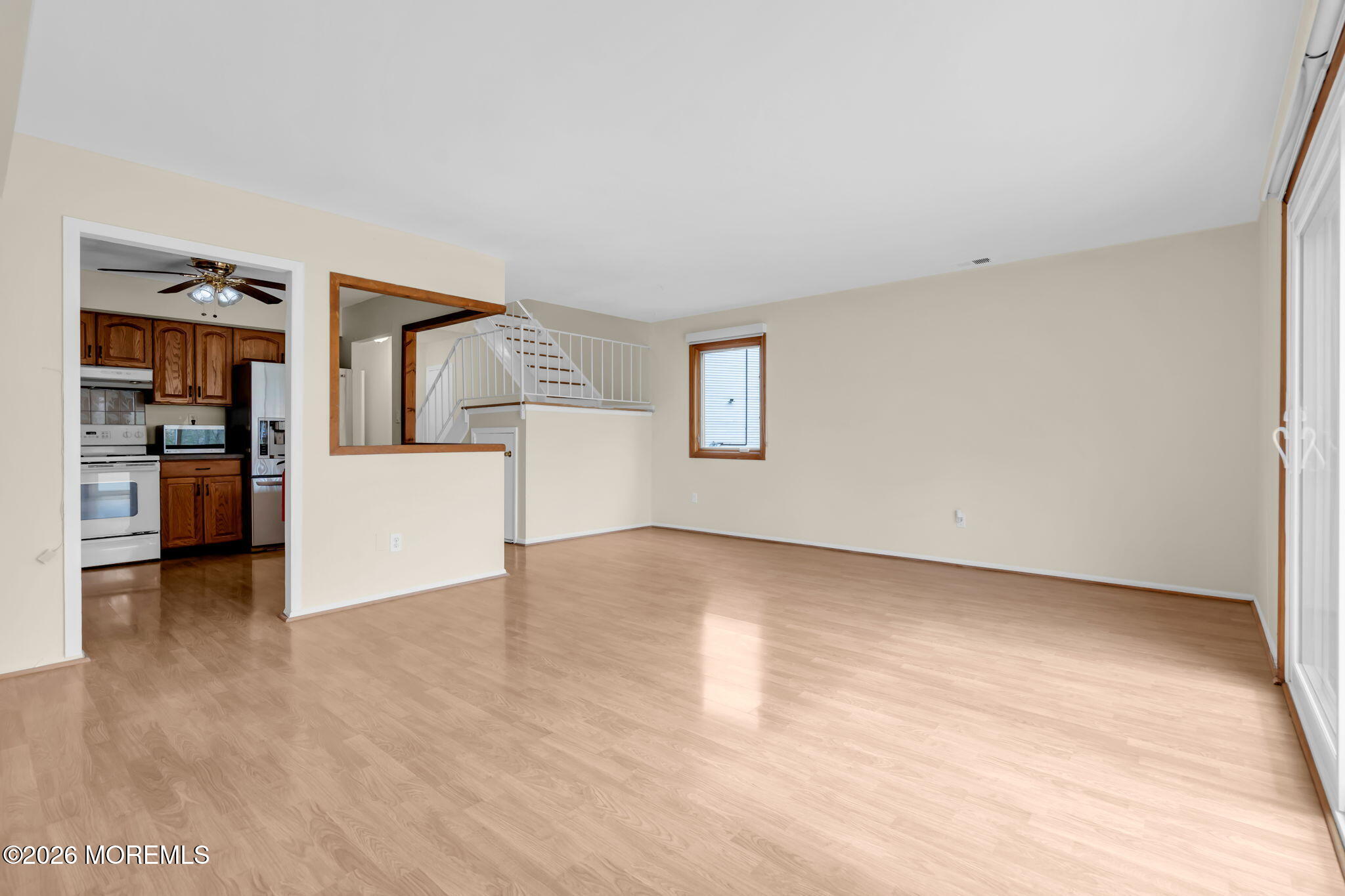 633 Randall Way Aberdeen, NJ 07747 - Photo 9 of 28 a view of a livingroom with an empty space and a refrigerator