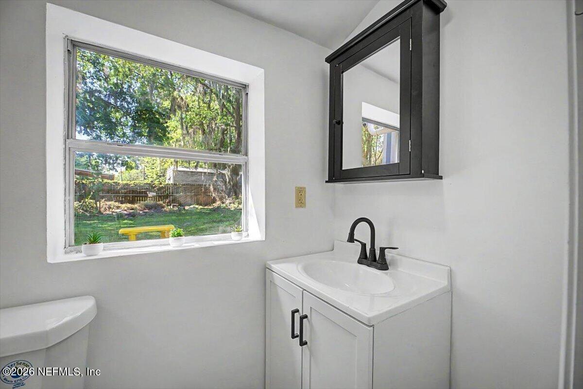 2520 Larsen Road Jacksonville, FL 32207 - Photo 22 of 27 a bathroom with a toilet sink and window