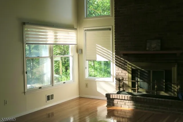 an empty room with a window and a ceiling fan