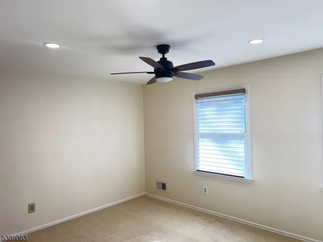 a living room with a fireplace and a floor to ceiling window