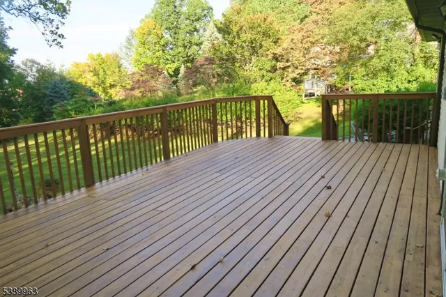 a balcony with wooden floor and fence