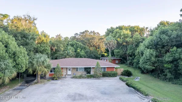 an aerial view of a house with a yard and garden