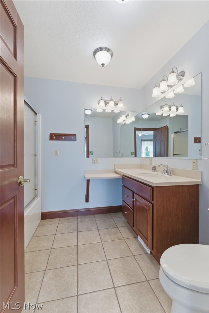 2184 Brenner Road Northeast Carrollton, OH 44615 - Photo 26 of 50 Bathroom featuring a spacious vanity with an integrated sink, ample counter space, and wood-finish cabinetry