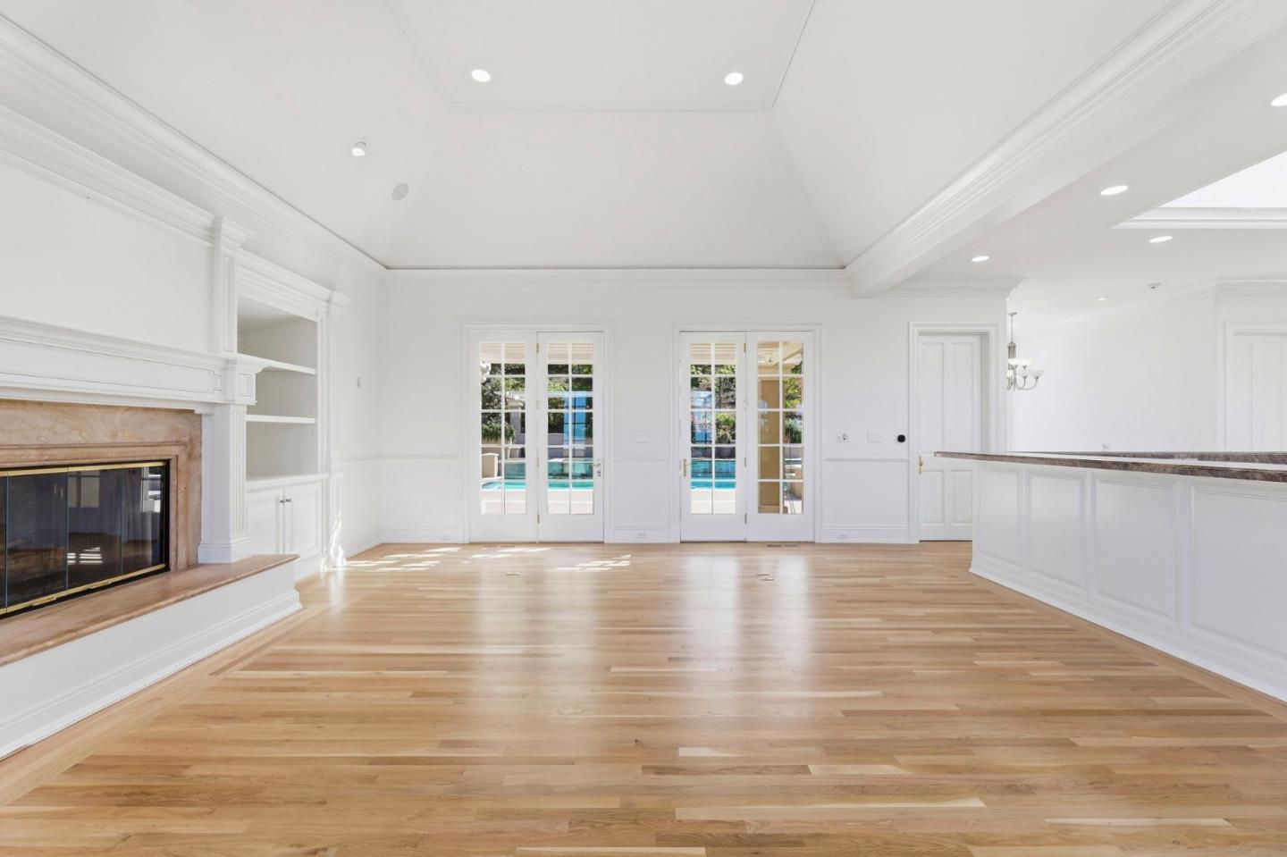 14113 Pike Road Saratoga, CA 95070 - Photo 26 of 78 a view of an empty room with wooden floor fireplace and a window