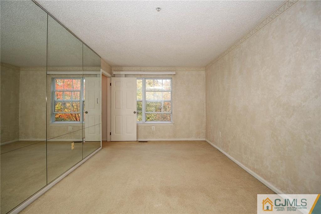 263 Prestwick Way, Unit 263 Edison, NJ 08820 - Photo 14 of 23 a view of an empty room with a window