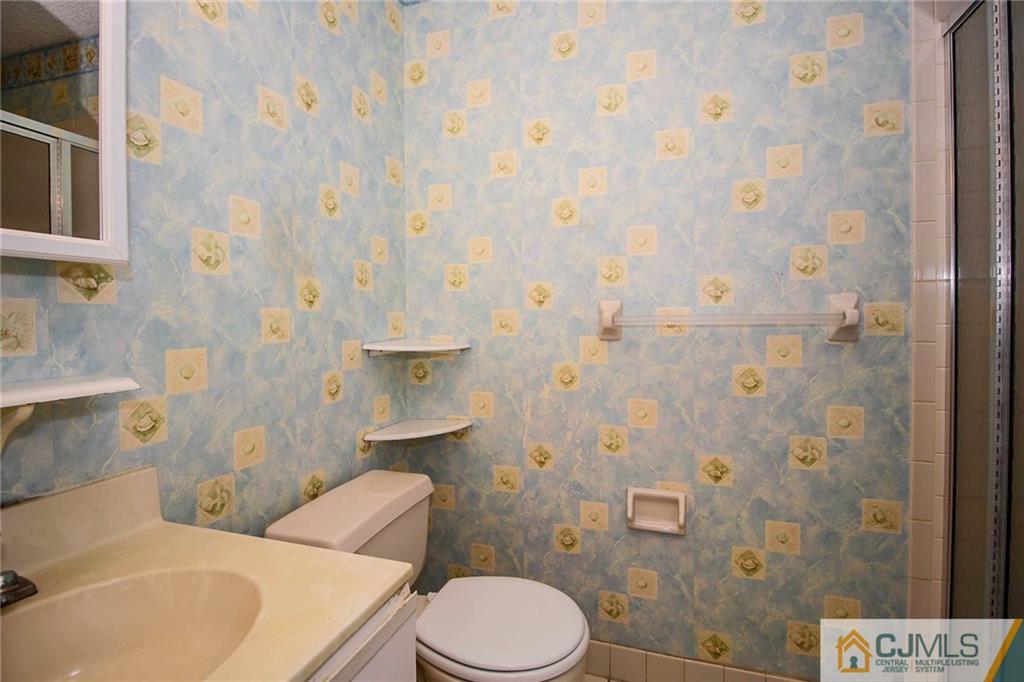 263 Prestwick Way, Unit 263 Edison, NJ 08820 - Photo 17 of 23 a white toilet sitting next to a shower curtain