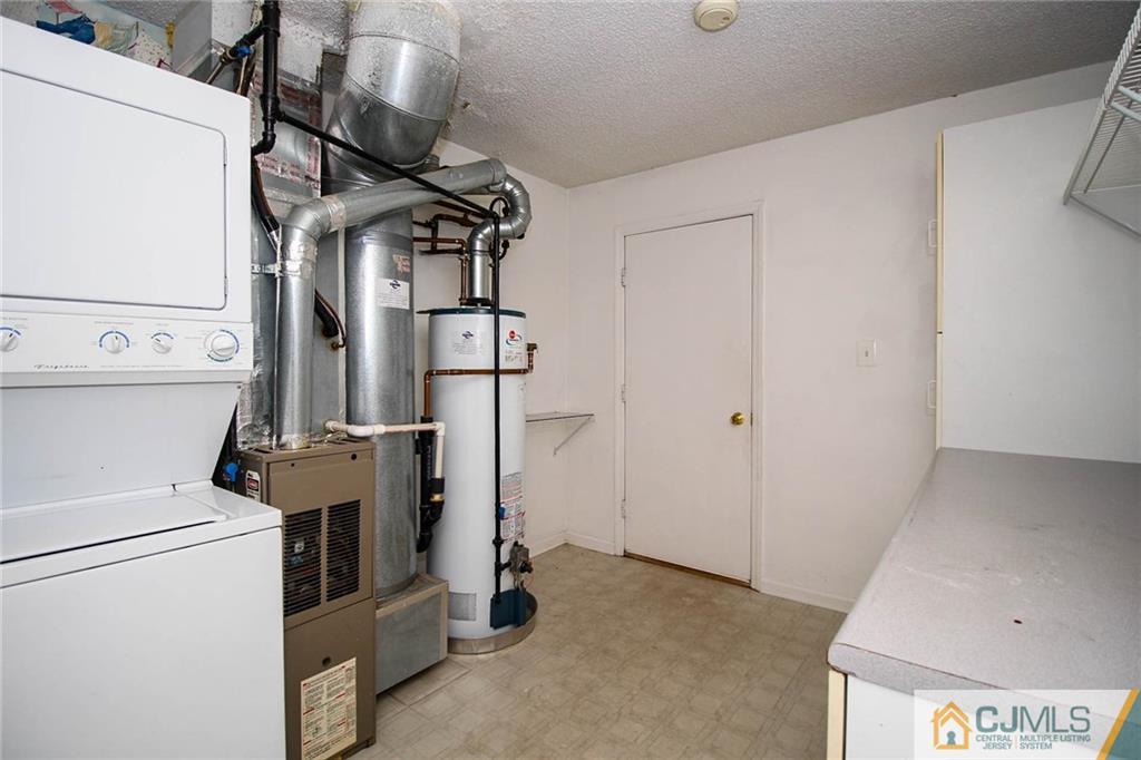 263 Prestwick Way, Unit 263 Edison, NJ 08820 - Photo 19 of 23 a view of storage and utility room with washer and dryer
