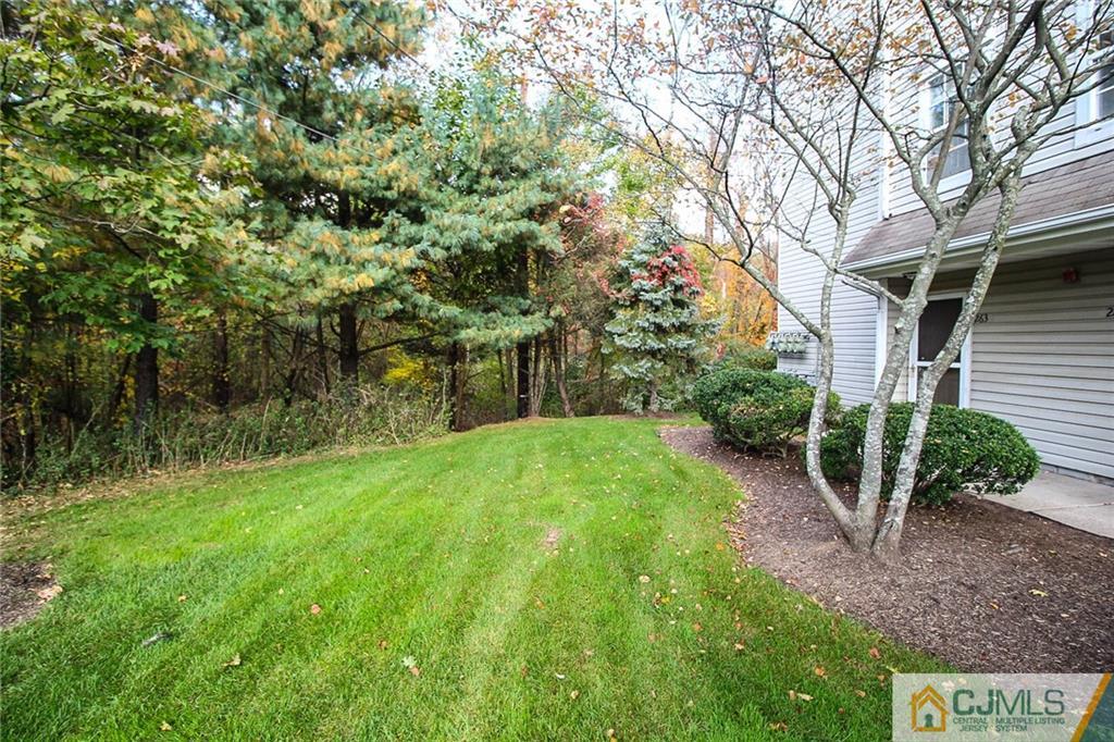 263 Prestwick Way, Unit 263 Edison, NJ 08820 - Photo 3 of 23 a view of a garden with plants and large trees