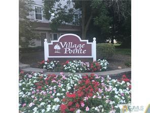 263 Prestwick Way, Unit 263 Edison, NJ 08820 - Photo 23 of 23 a sign that is in front of flowers