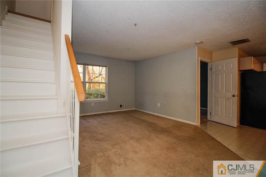 263 Prestwick Way, Unit 263 Edison, NJ 08820 - Photo 7 of 23 a view of an empty room with a window