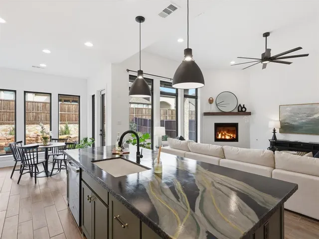 a living room with furniture a fireplace and a floor to ceiling window