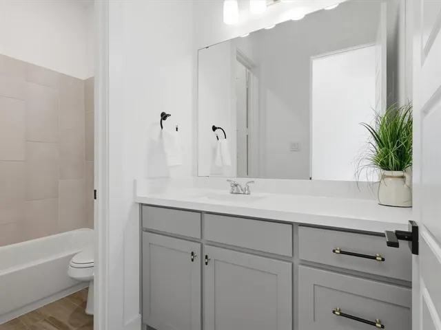 a bathroom with a sink a toilet and vanity