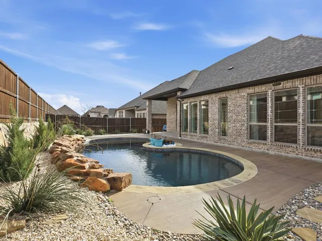a view of a brick house with large windows