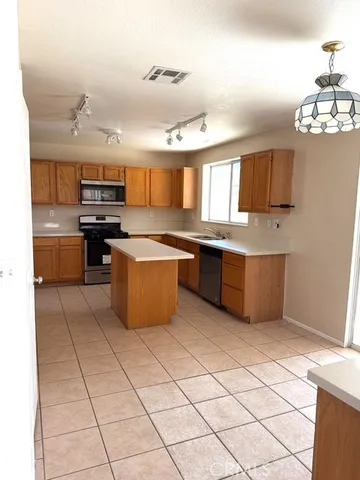 a kitchen with stainless steel appliances granite countertop a sink counter space cabinets and a window