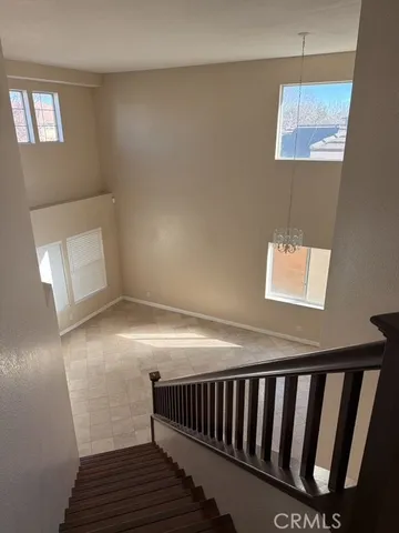 a view of staircase with white walls and a window